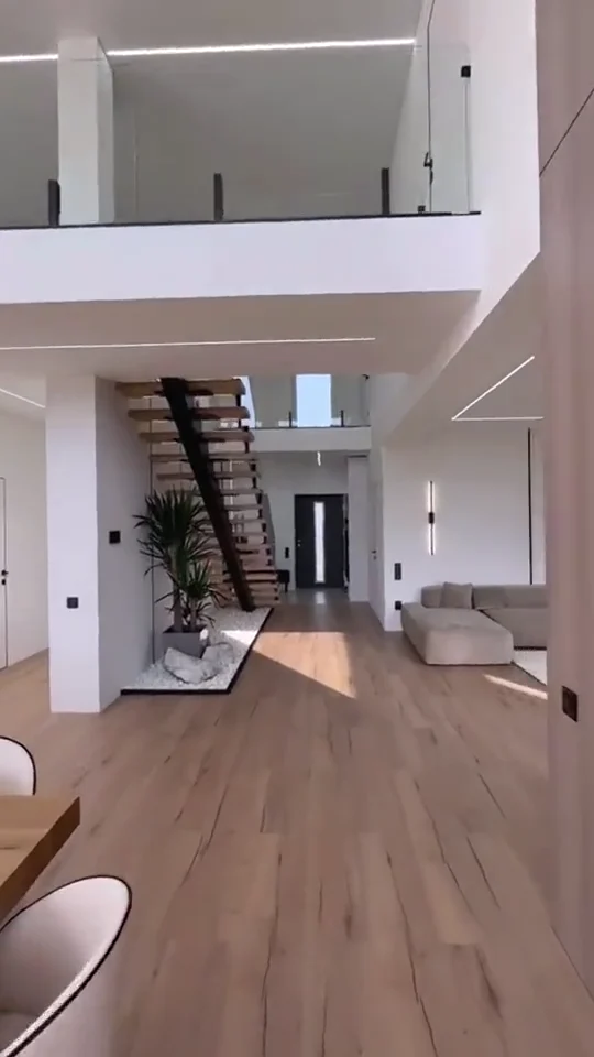 Bright living room with sculptural seating and full-height windows